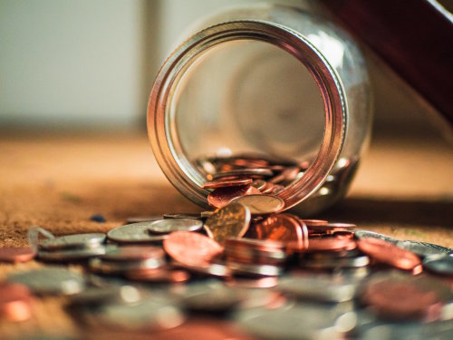 Coins spilling out from a jar