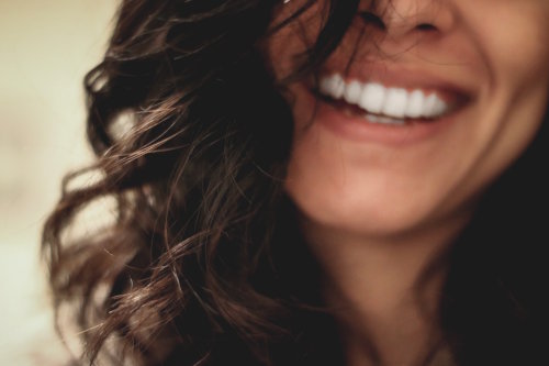Close-up of a woman laughing with a beautiful smile and white teeth